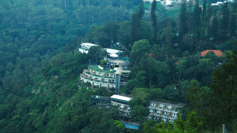 Drone shot of the hotel surrounded by the mountains and lush greenery - Great Trails Yercaud by GRT Hotels
