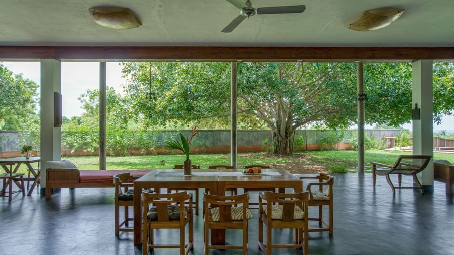 Villa dining area with wooden table in the center alongwith several chairs around it, perfect for a morning refreshment.