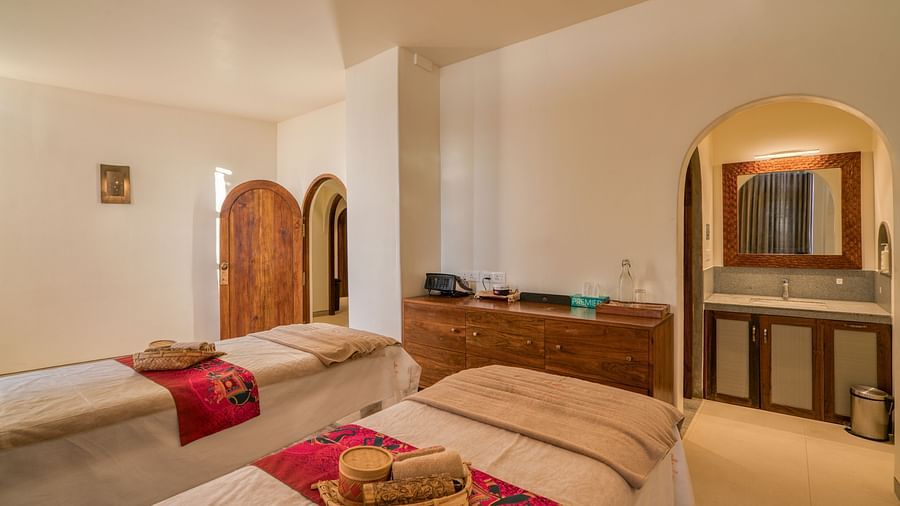 A cozy spa room with two treatment beds, warm tones, and a relaxing ambiance.  | Mango Hill, Yercaud