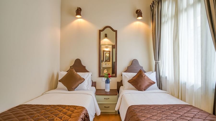 Twin beds inside the bedroom villa with a balcony | Mango Hill Shola Ooty