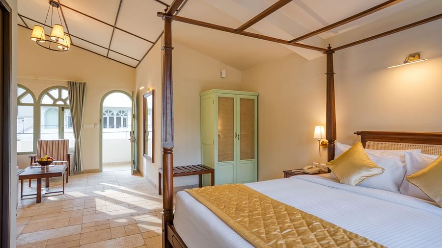 A close up shot of the double bed with golden runner and pillows | Mango Hill Shola Ooty
