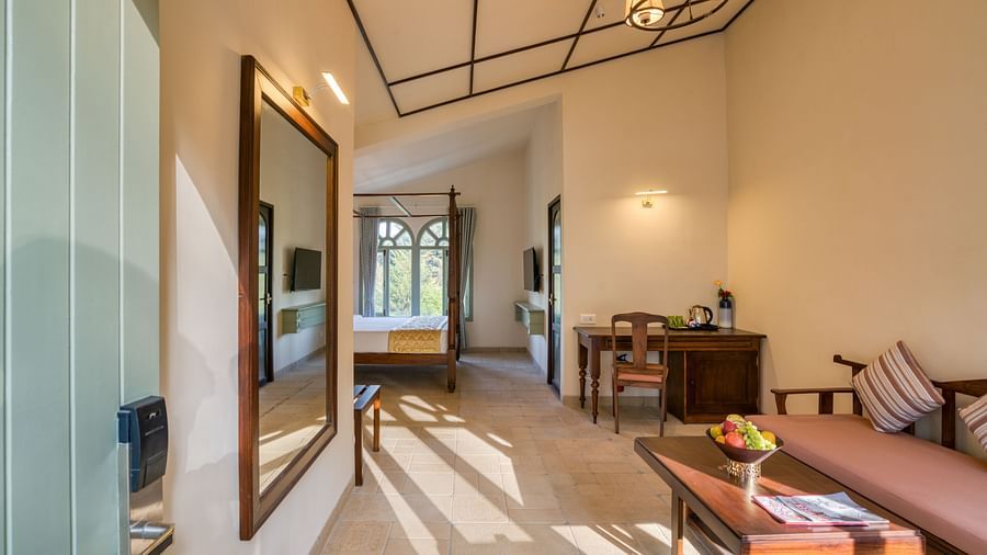 Overview of the living room with sofas inside deluxe room | Mango Hill Shola Ooty