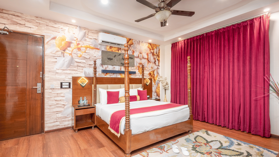 Double bed room with artistic wall décor at DLS Hotels On The Ganges.