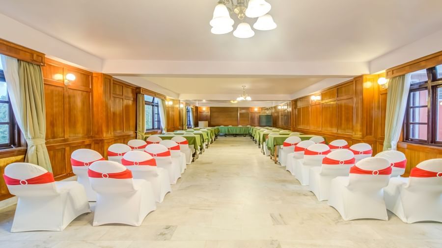 Image of a banquet hall with a chandelier hanging from the ceiling at Summit Tashi Ghang Heritage Resort, Pelling