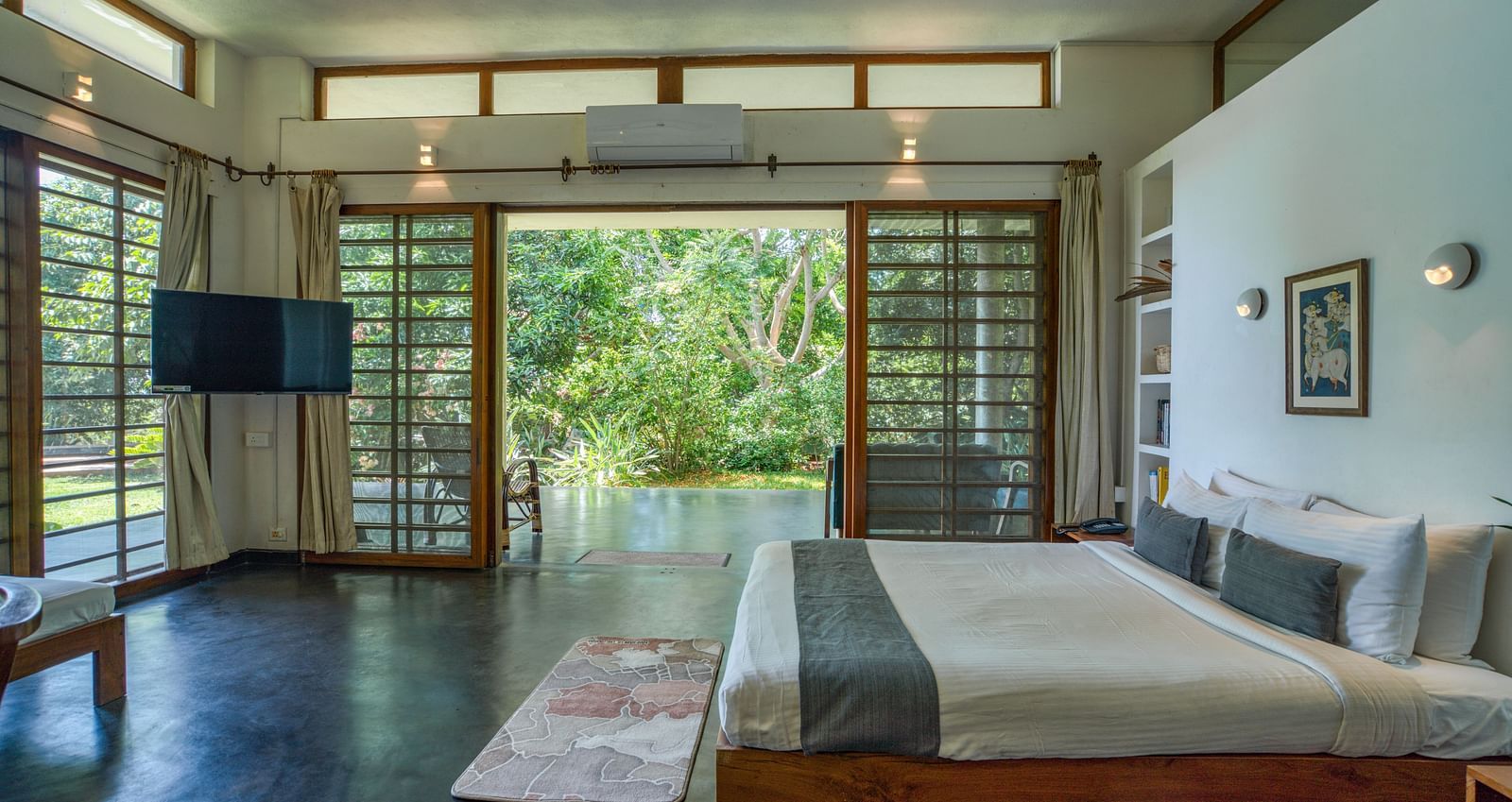 Bright and airy living room with comfortable seating and direct access to the pool.
