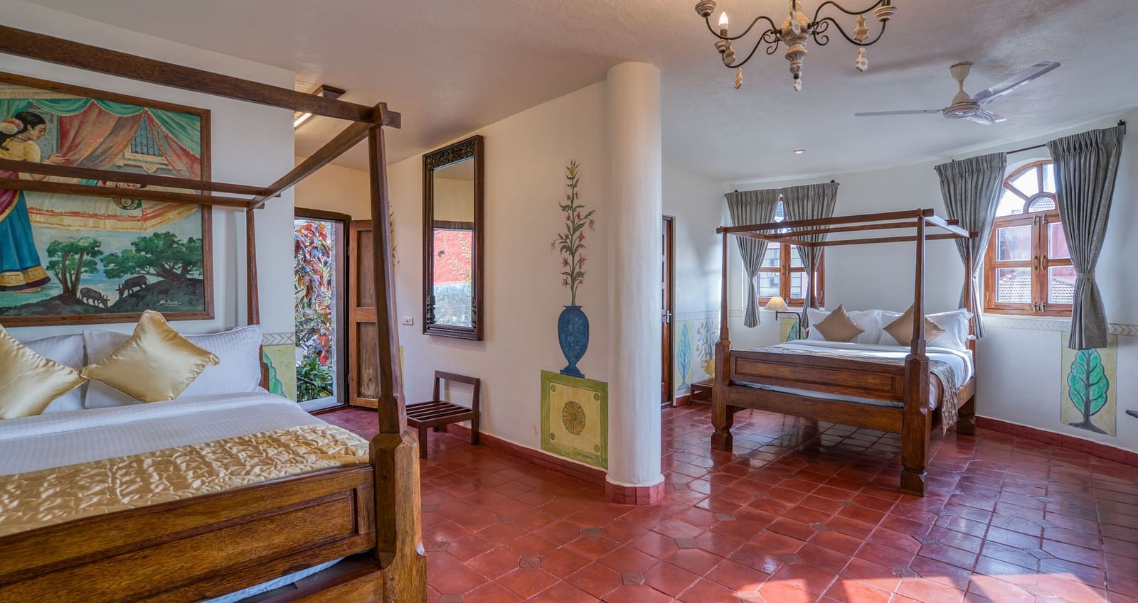 Spacious room with two four-poster beds, chandelier, and large windows providing natural light. | Mango Hill, Yercaud