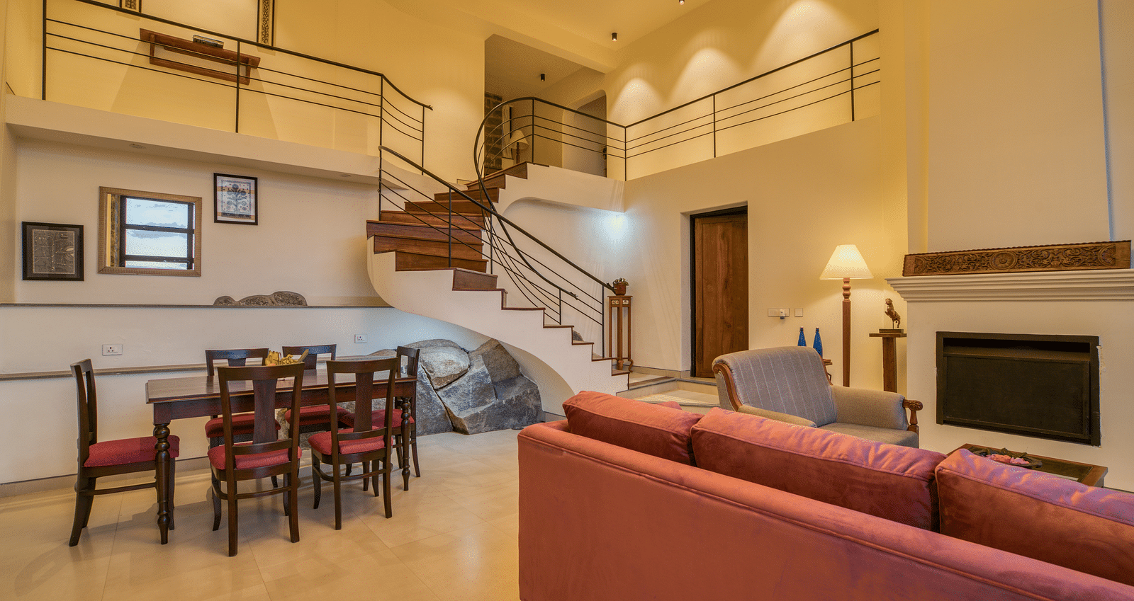 A luxurious living room with attached indoor stairs leading to the first floor | Mango Hill, Yercaud