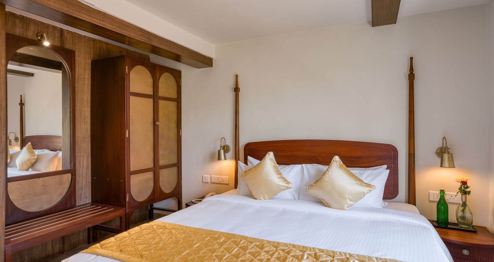 A double bed with a wardrobe next to it inside junior suite | Mango Hill Shola Ooty