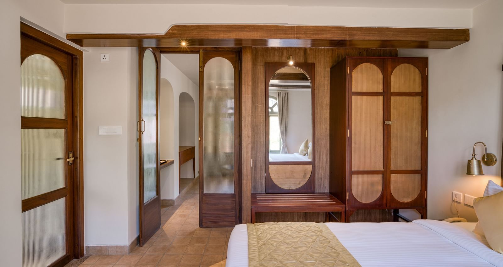 A double bed with a wardrobe next to it inside junior suite |  Mango Hill Shola Ooty