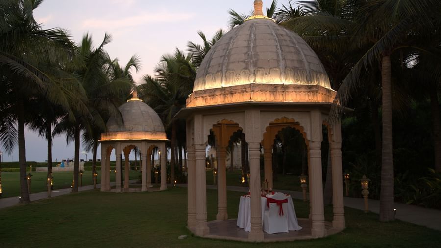 A serene outdoor dining experience with multiple gazebos in a lush green setting - Kaldan Samudhra Palace