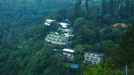 Drone shot of the hotel surrounded by the mountains and lush greenery - Great Trails Yercaud by GRT Hotels