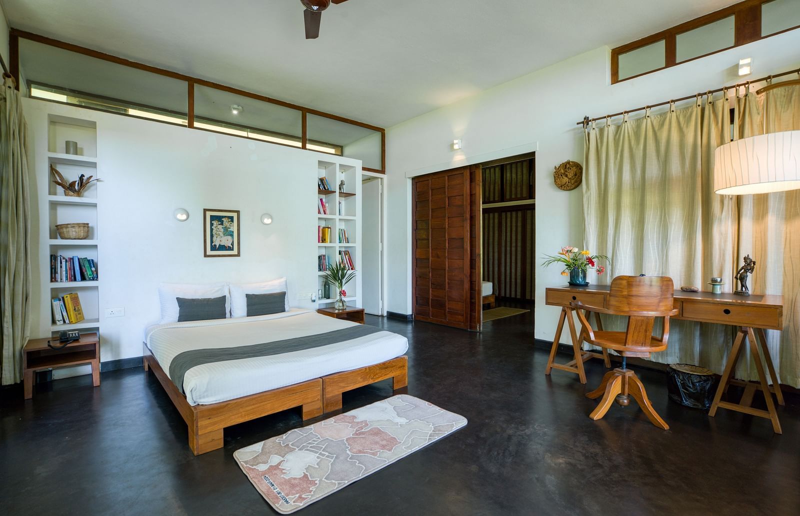 Elegant bedroom with a king-size bed, air conditioning, and modern decor.