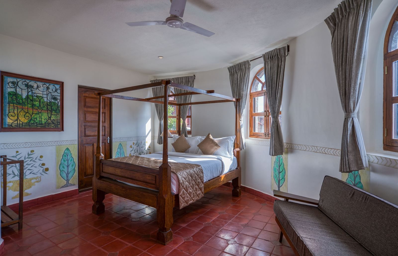 Hotel room with a four-poster bed, large windows, and rustic decor. | Mango Hill, Yercaud