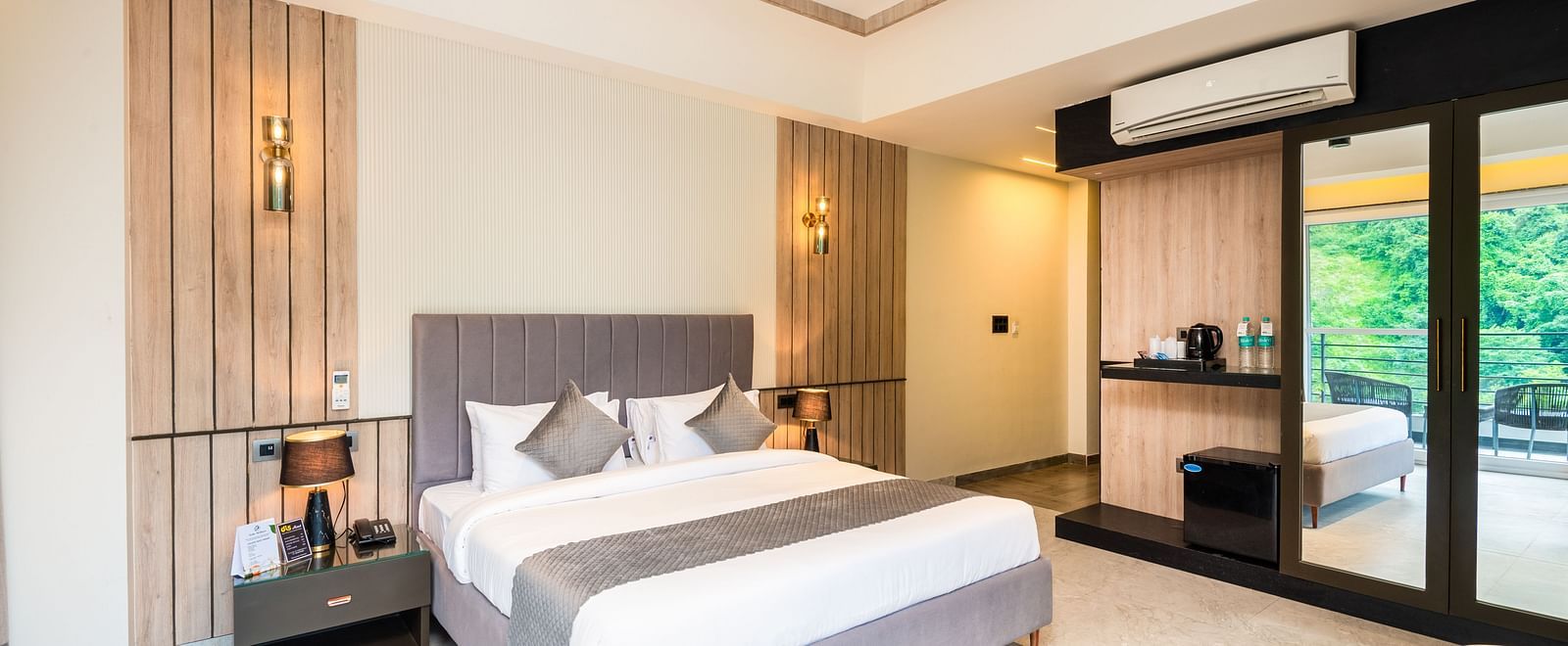 Spacious bedroom with balcony  and king bed at DLS Divine River Resort & Spa, Rishikesh.