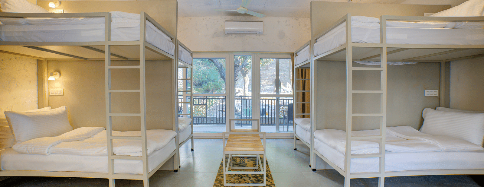 Front view of bedroom with Bunk Beds across from each other with a small table in between - Bedzzz, Rishikesh