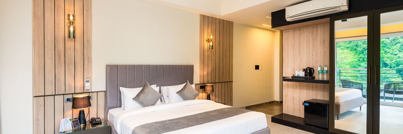 Spacious bedroom with balcony  and king bed at DLS Divine River Resort & Spa, Rishikesh.
