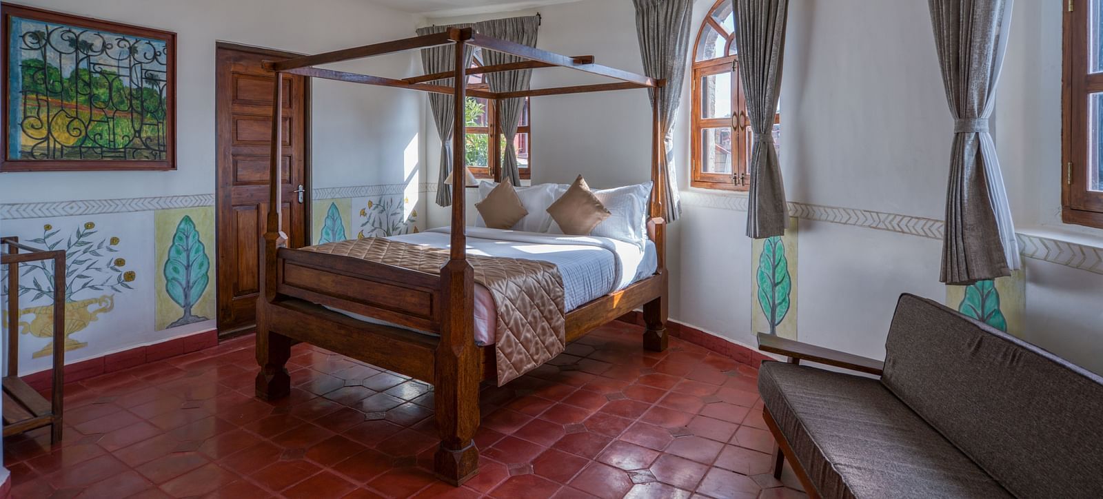 Hotel room with a four-poster bed, large windows, and rustic decor. | Mango Hill, Yercaud