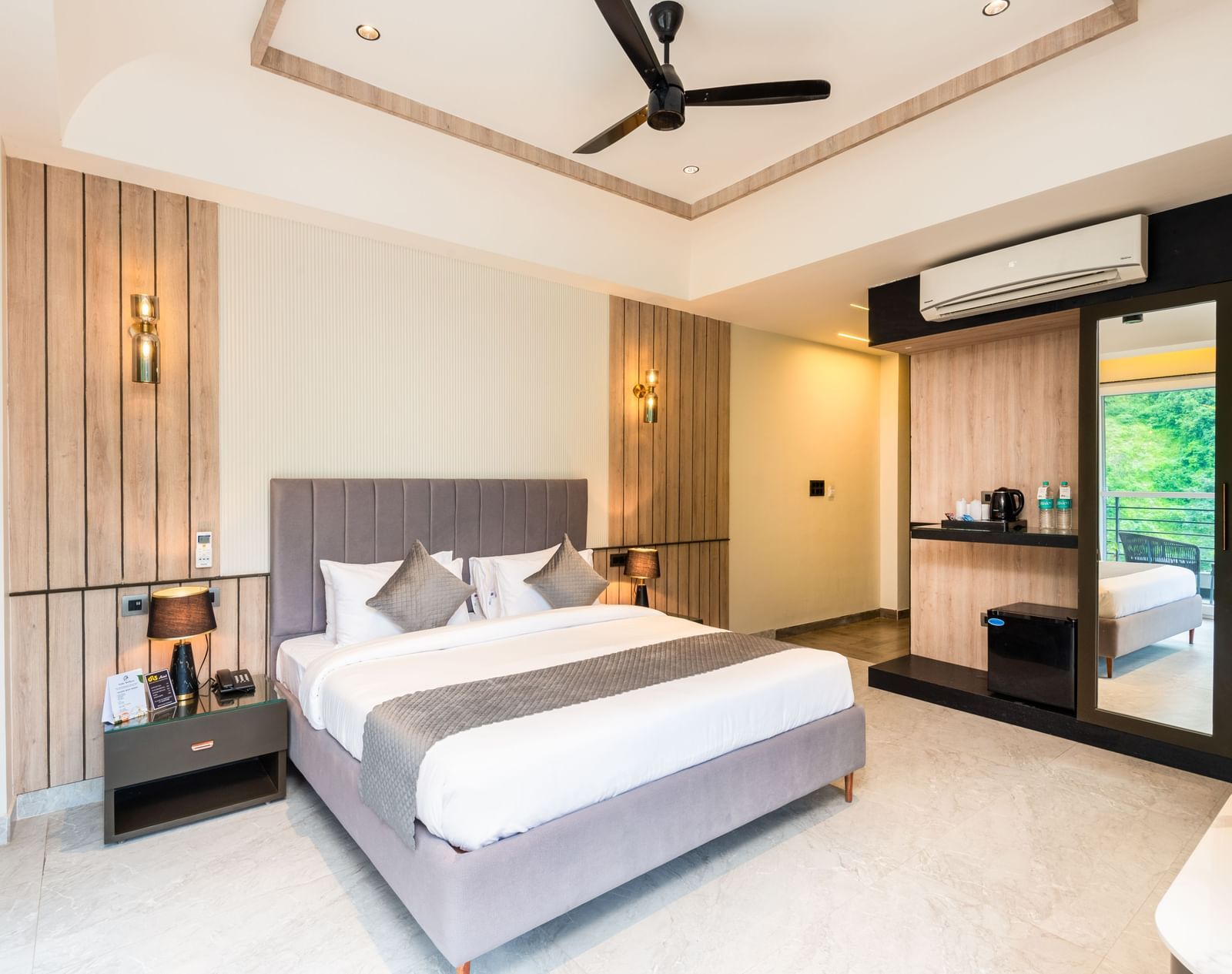 Spacious bedroom with balcony  and king bed at DLS Divine River Resort & Spa, Rishikesh.