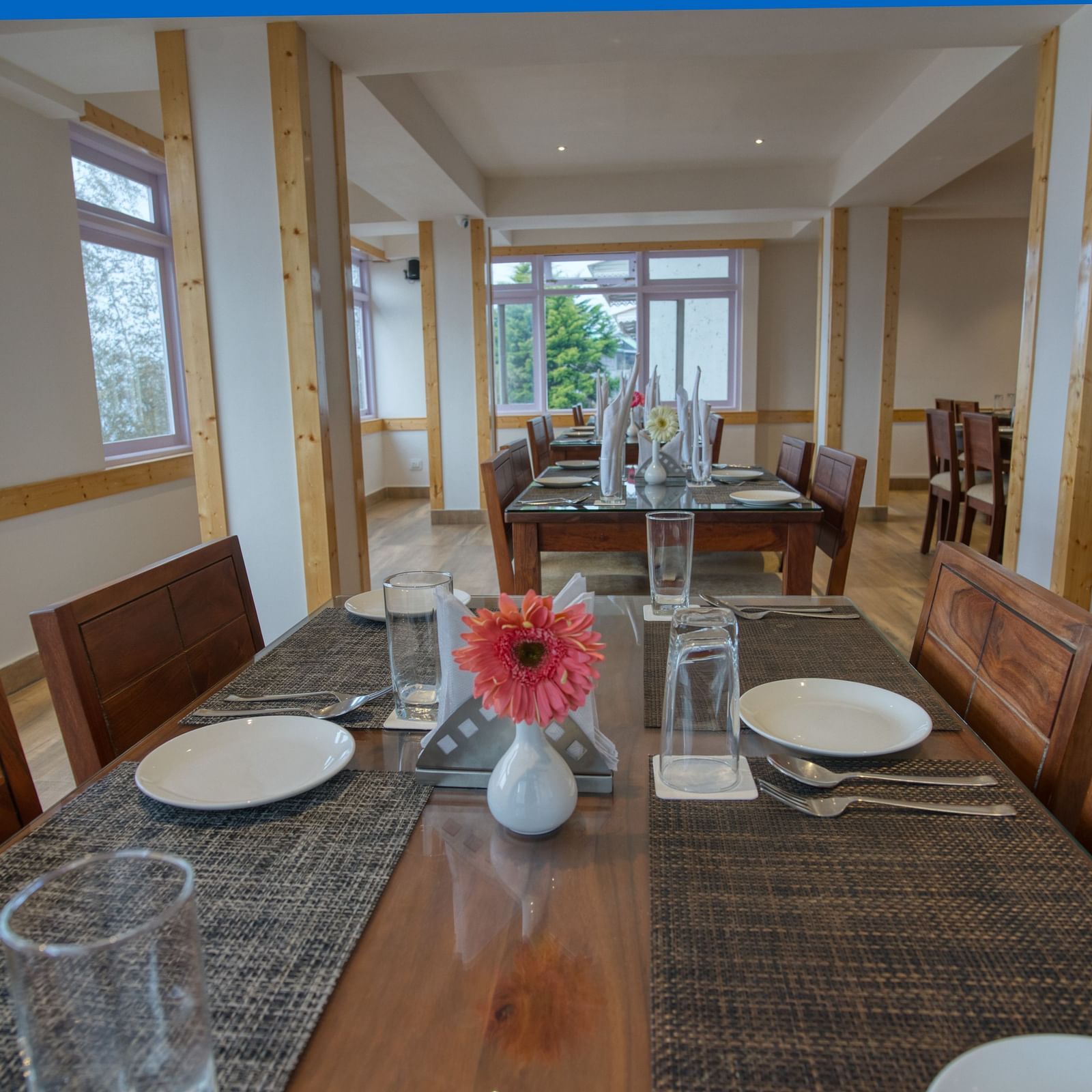 Dining space with seating area and a vase of flower on the table at Gangtok prime