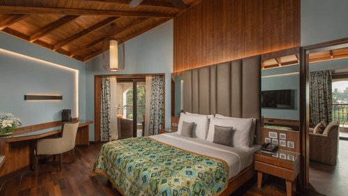 The Sea View Suite King Bed looks quite welcoming placed amidst wooden floors and light blue walls