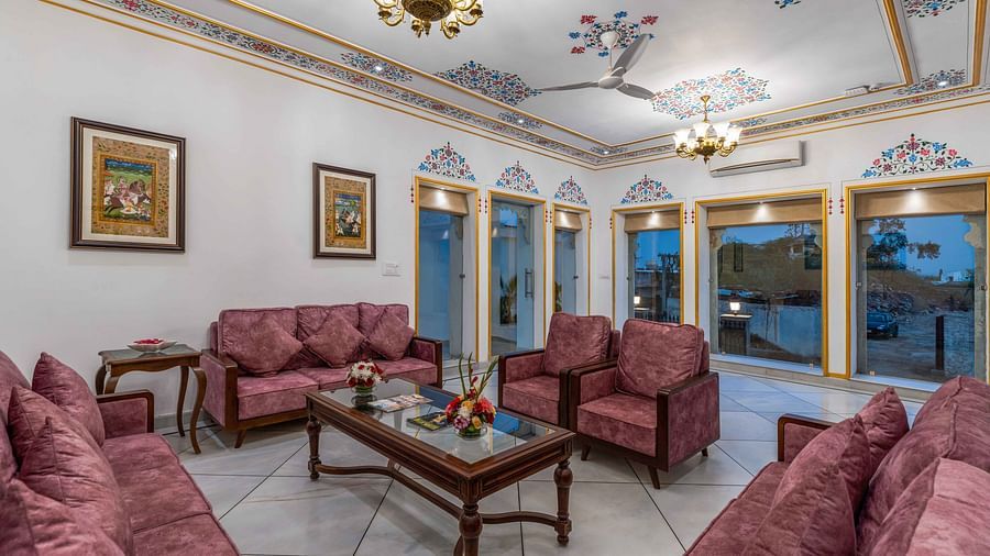 Seating area with comfortable sofas and coffee table at Maan Vilas by Stone Wood, Udaipur