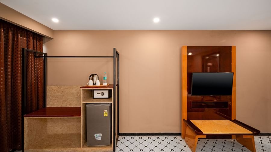 A close-up of a stylishly designed bed and cosy seating area, offering a relaxing atmosphere at Crescent Resort, Goa