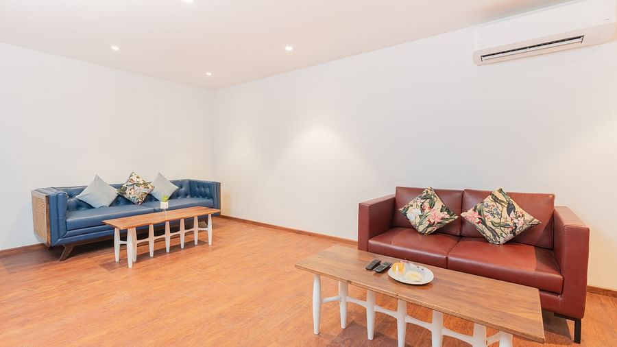 image of the living room of the family villa two bedroom with two couches of brown and turquoise colour - Darza Resorts