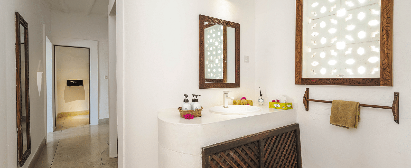 View of vanity with a mirror, sink, towel and window on the side in Sea View Family Cottages - Shooting Star Boutique Hotel.