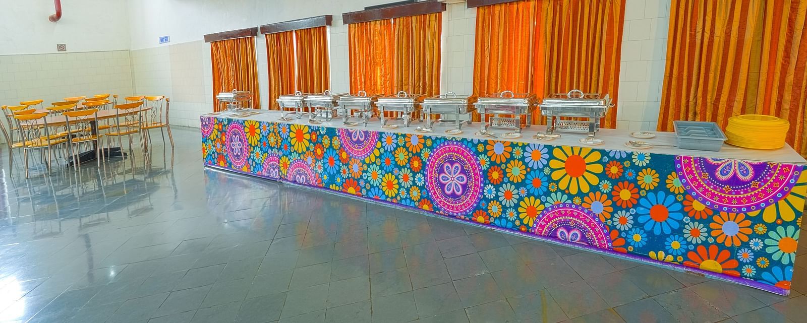 A cafeteria serving area with a floral counter at Sahara - Unique Dining in Hyderabad.