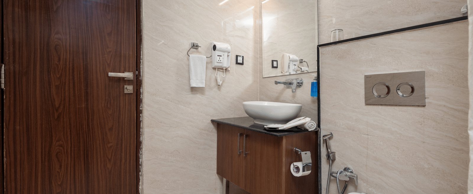 Modern bathroom with toilet and shower at DLS Hotels On The Ganges.