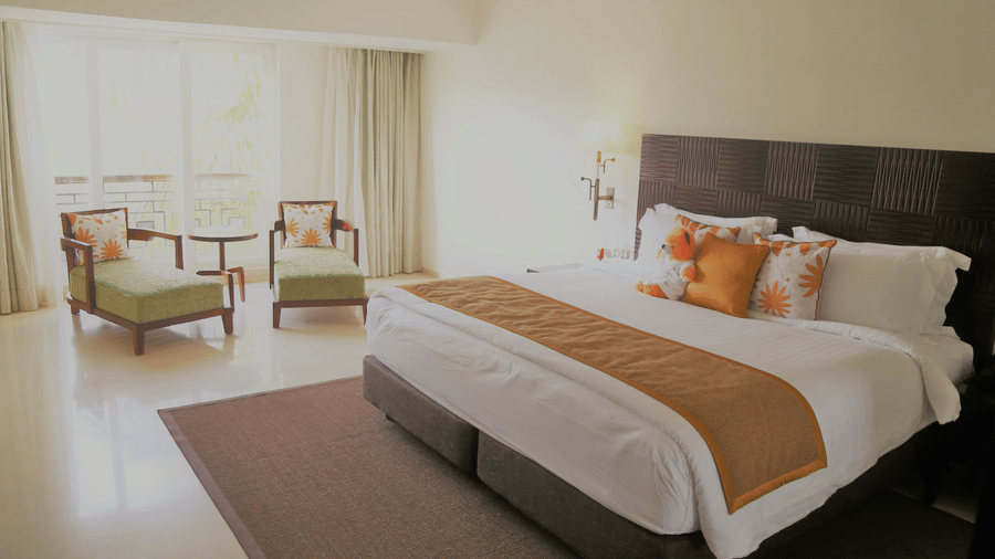 Spacious guest room at The Mansion House with stylish interiors, comfortable bedding, contemporary furnishings and essential amenities, designed to provide a relaxing and comfortable stay.