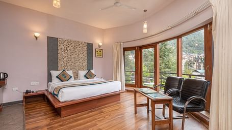 Overview of Luxury Cottage at DLS Spring Valley Resort Dharamshala featuring a king size bed, table , chairs,and a big balcony