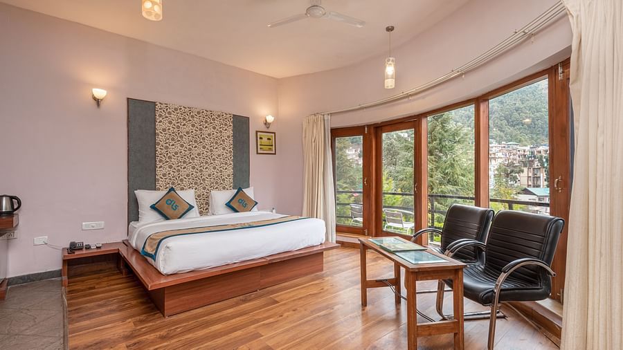 Overview of Luxury Cottage at DLS Spring Valley Resort Dharamshala featuring a king size bed, table , chairs,and a big balcony
