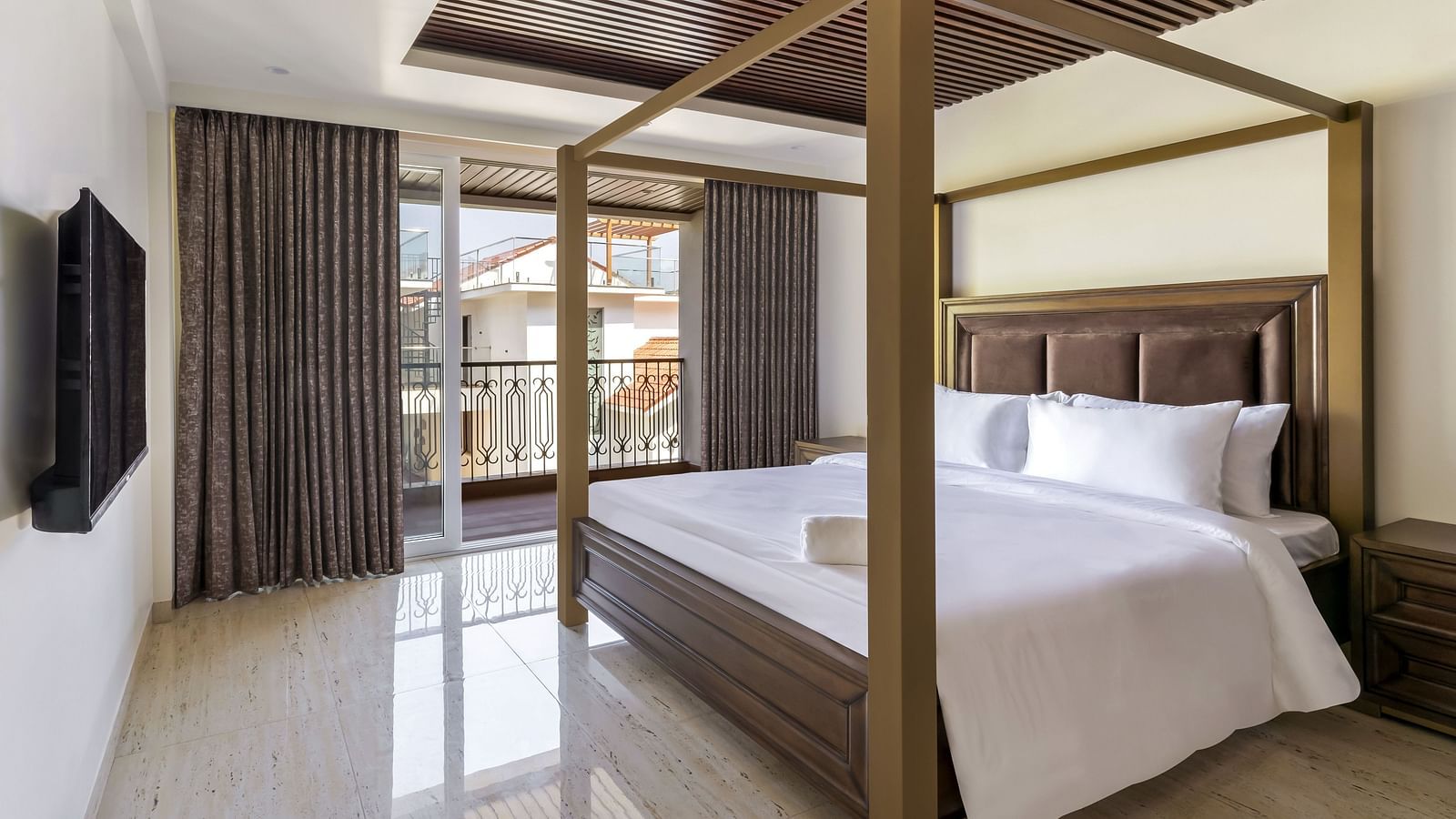 A double bed with wooden beams inside one of the rooms - The Tanisi Hotels & Resorts, Goa