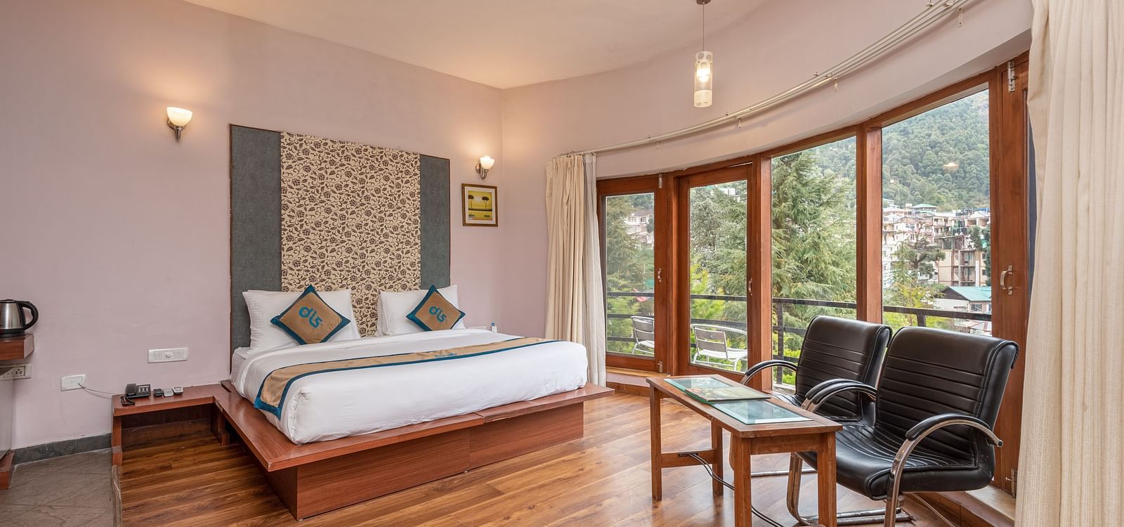 Overview of Luxury Cottage at DLS Spring Valley Resort Dharamshala featuring a king size bed, table , chairs,and a big balcony