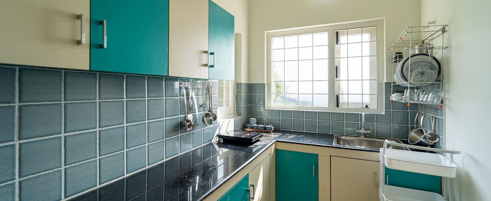 an overview of a kitchen area with cupboards and a sink inside one of the rooms - neer ganga Resorts