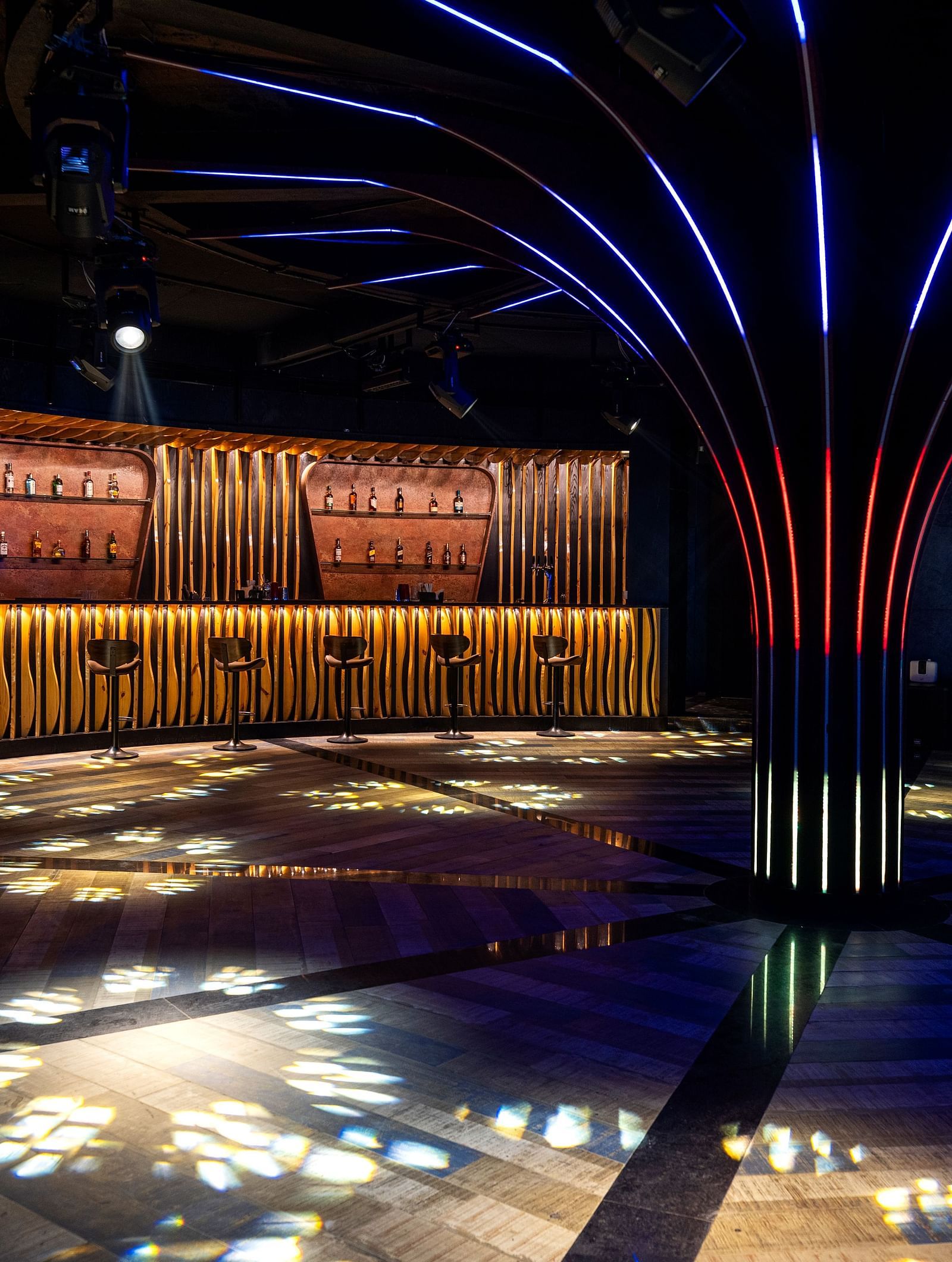 Verve featuring decorative lighting, dark walls, and reflective flooring at The Qualia Resort Club & Brewery, Udaipur.