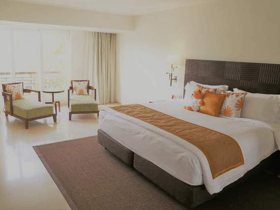 Spacious guest room at The Mansion House with stylish interiors, comfortable bedding, contemporary furnishings and essential amenities, designed to provide a relaxing and comfortable stay.