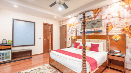 Spacious double bed room with wooden flooring at DLS Hotels On The Ganges.