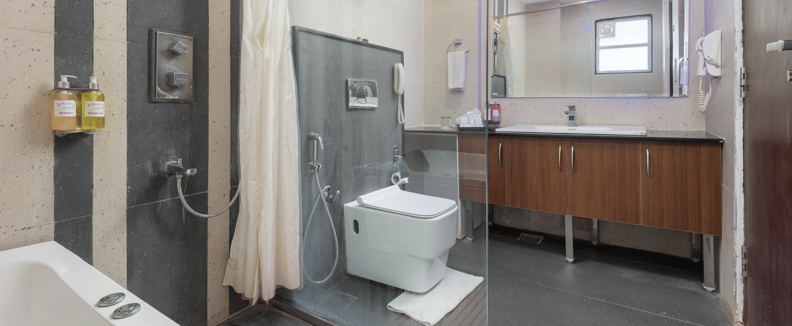 Accessible bathroom with shower, toilet, and grab bars at DLS Hotels On The Ganges.