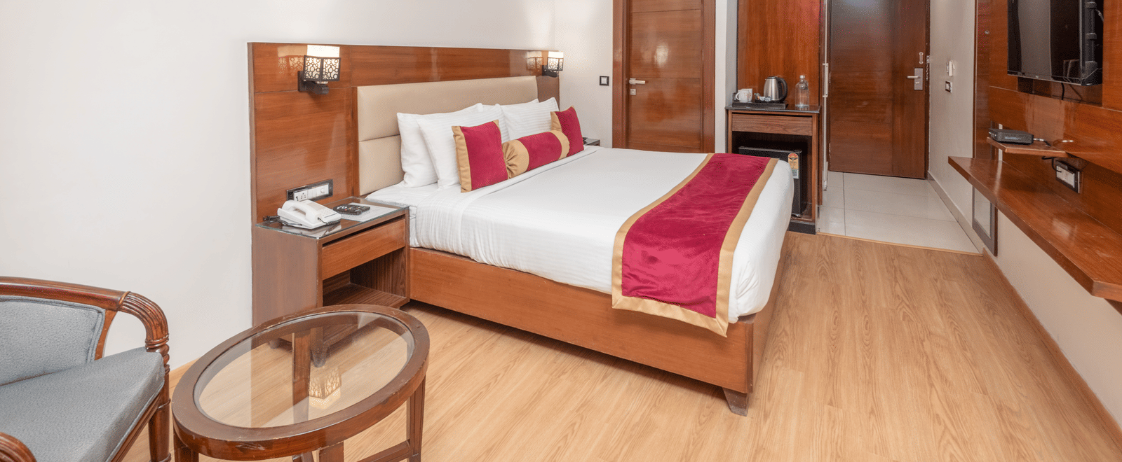 Spacious bedroom with double bed and seating at DLS Hotels On The Ganges.