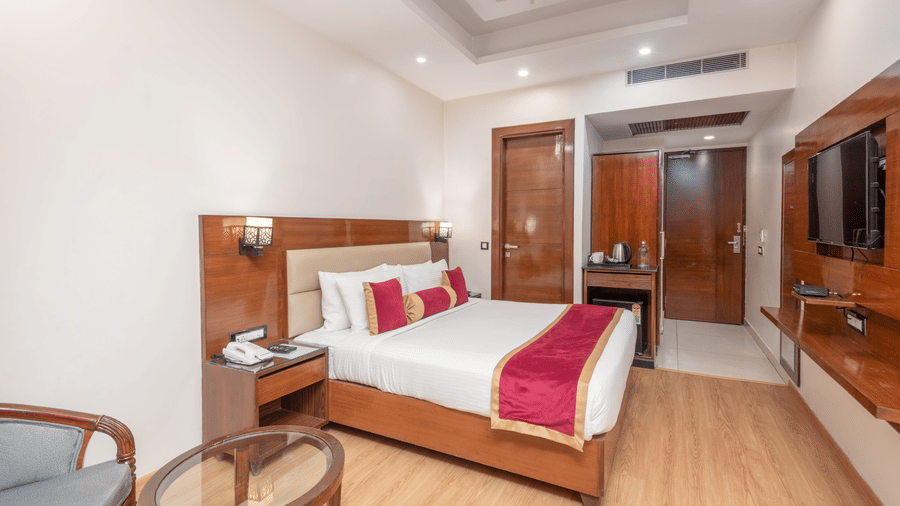 Spacious bedroom with double bed and seating at DLS Hotels On The Ganges.