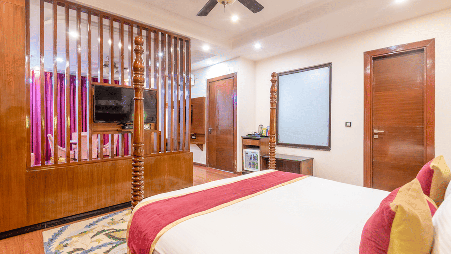 Bedroom with wooden flooring and partition wall at DLS Hotels On The Ganges.