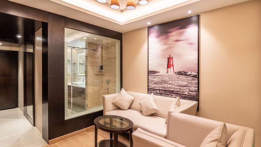 Spacious hotel suite with modern seating area and wall art fortuna- TGI Grand Fortuna, Krishnagiri Main Road, Hosur