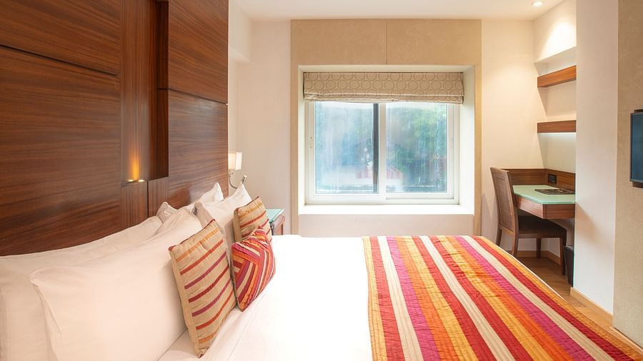 A side angle view of an executive room, showcasing the interior design and highlighting a window that offers a beautiful view outside