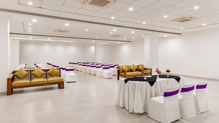 A event hall with white tables, chairs and couches in golden colour - Via Lakhela Resort & Spa