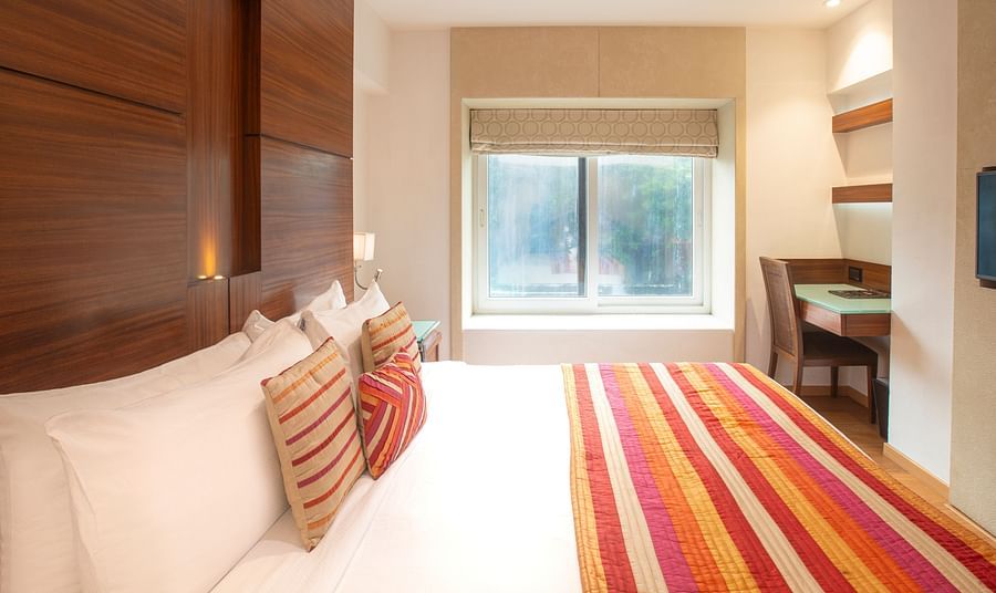 A side angle view of an executive room, showcasing the interior design and highlighting a window that offers a beautiful view outside