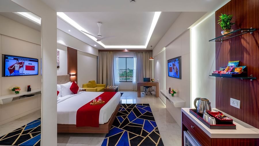Room with lounge area, modern furnishings, and a cozy sleeping zone - Lords Eco Inn Shapar Rajkot