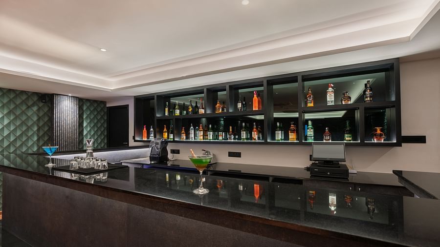 imge of the expansive bar with premium liquor collection at show in the back - Darza Resorts