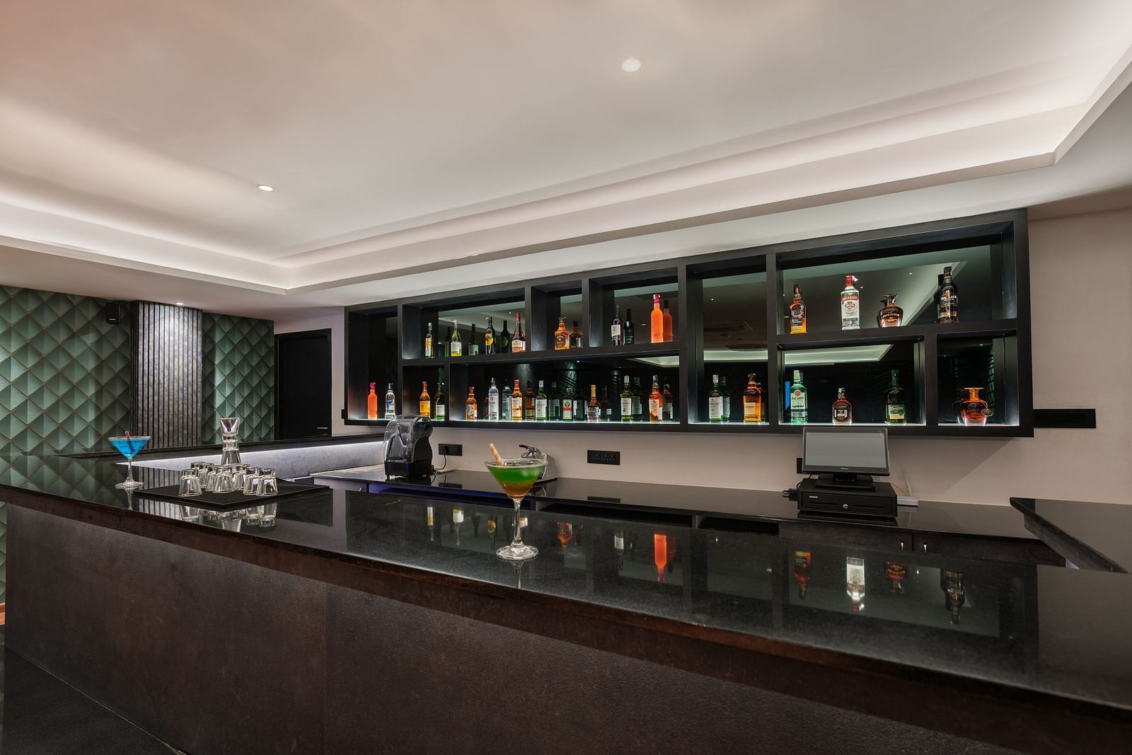 imge of the expansive bar with premium liquor collection at show in the back - Darza Resorts